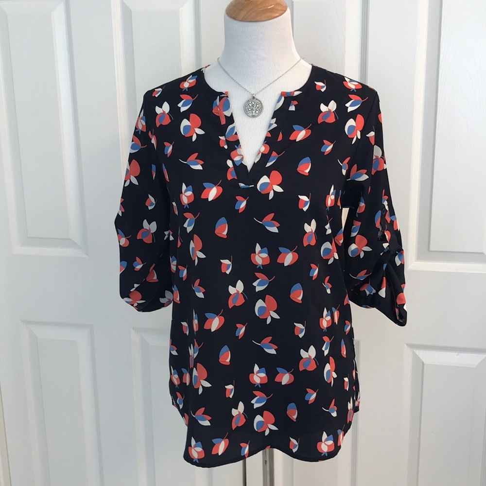 Pixley blue flowered top with tab sleeves.